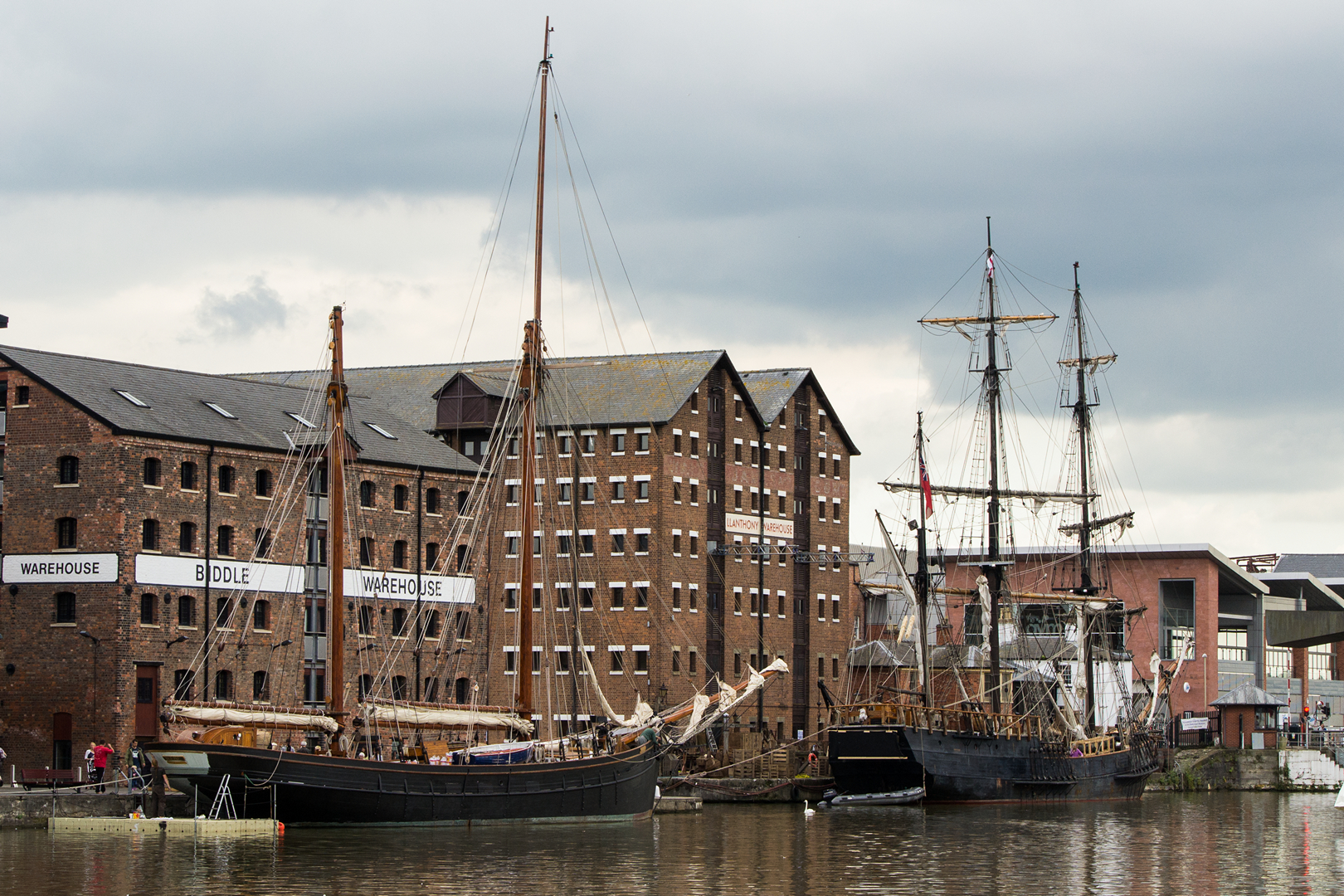 the ships are docked on the shore near buildings