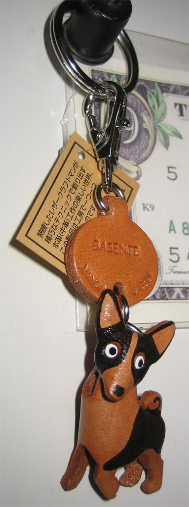 a dog keychain that is sitting on a table