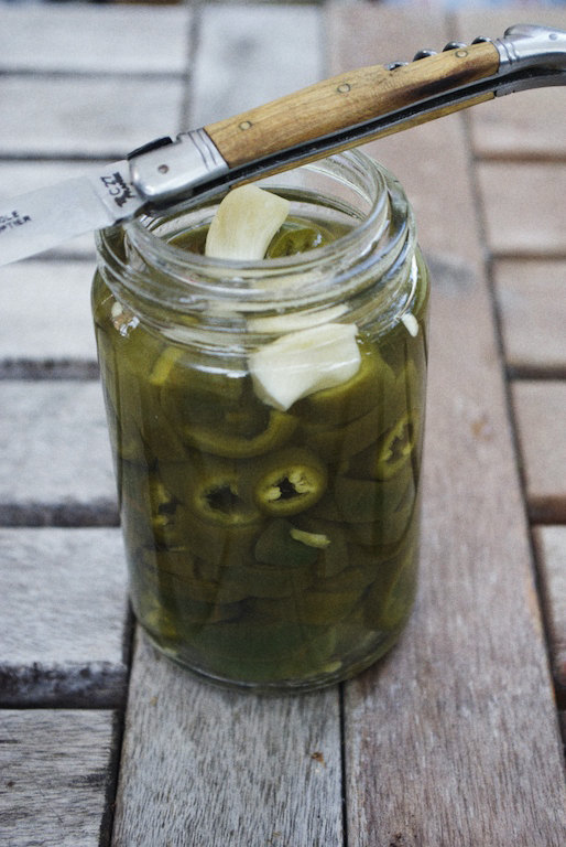 pickles sit in the jar on a picnic table