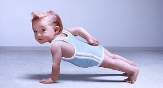 a toddler wearing a diaper on a yoga mat