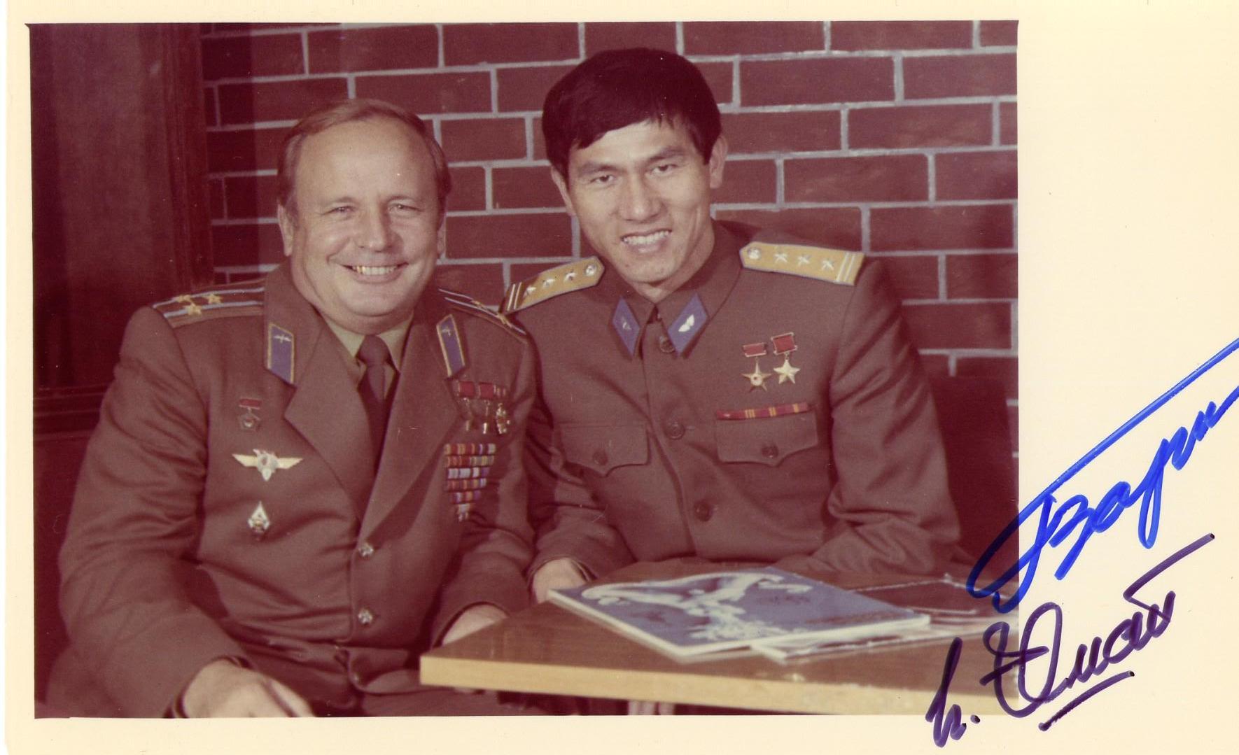 two men in uniform sitting together and posing