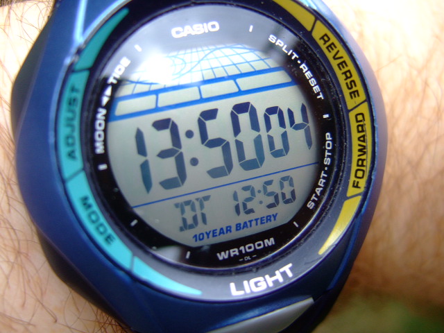a wrist watch displaying the time with blue, yellow and red accents