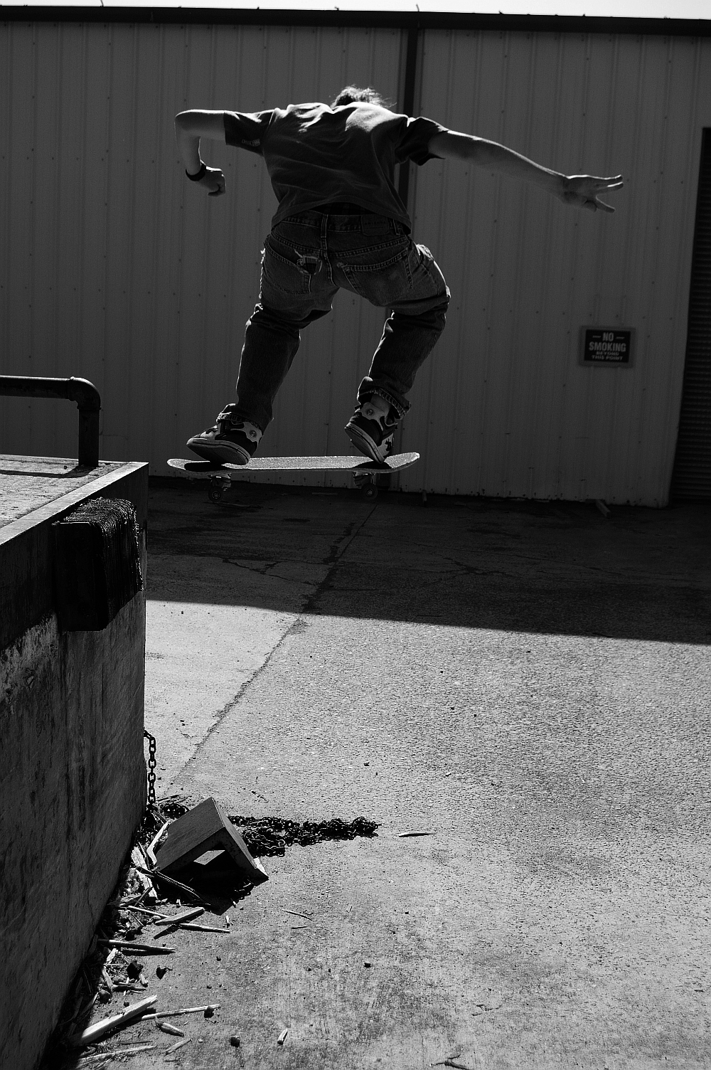 black and white po of a man jumping on a skateboard