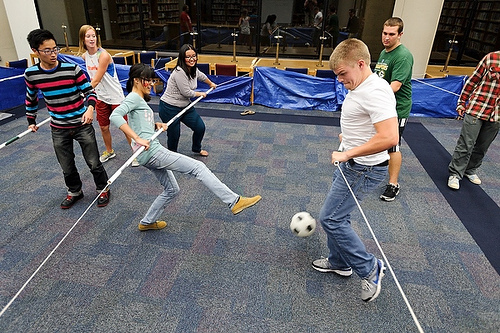 people in a classroom playing soccer while others watch