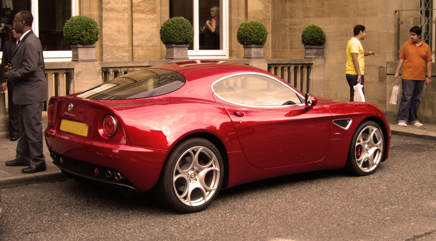 a red sports car parked on a side walk