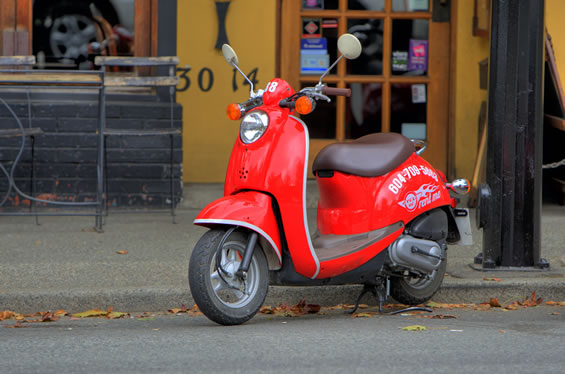 a moped parked on the side of a street