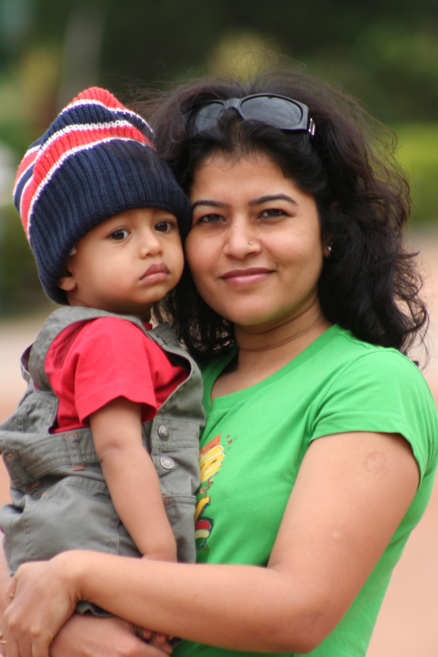 a woman holding a baby on top of her back