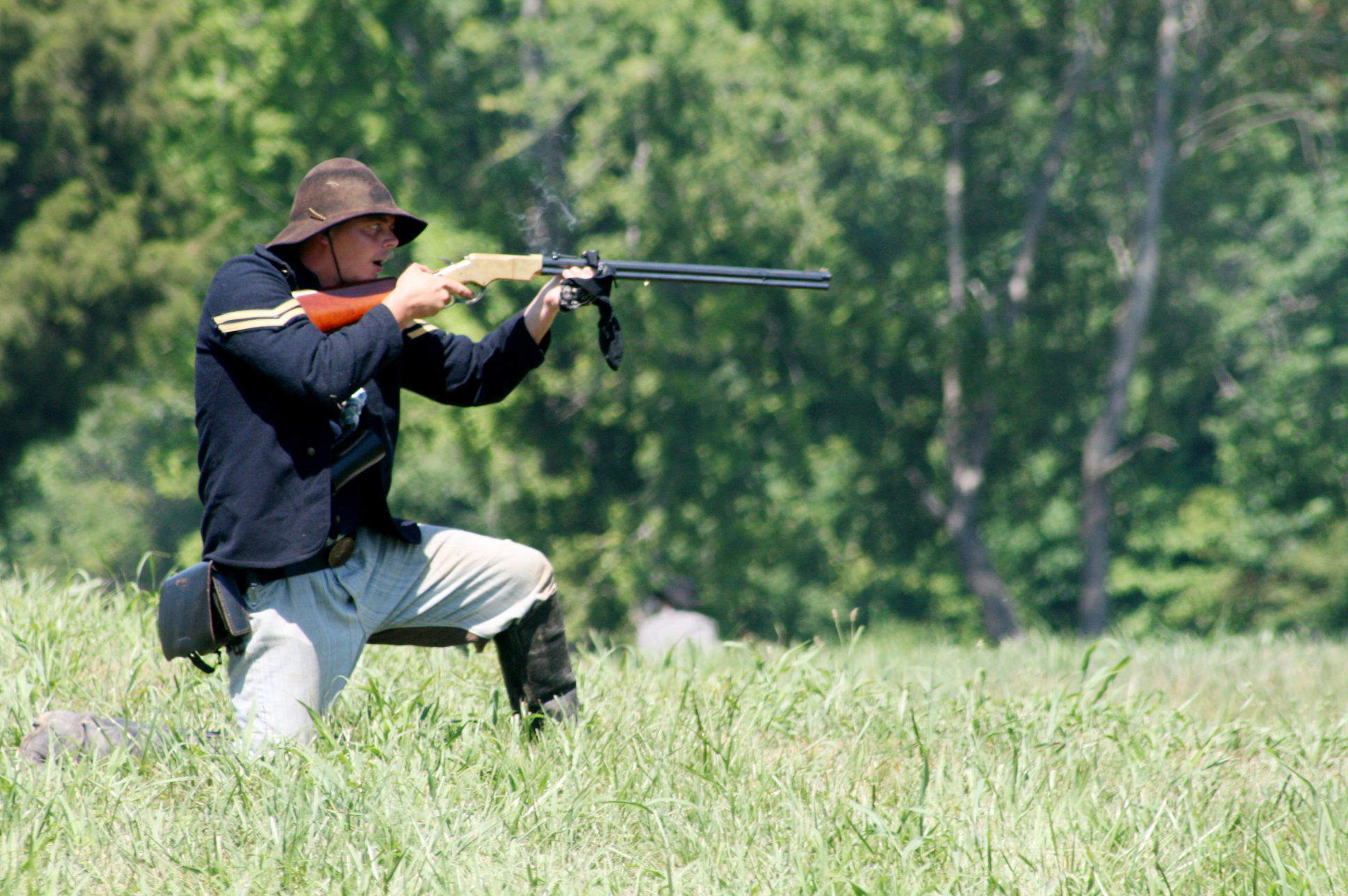 a man aiming his rifle at the target