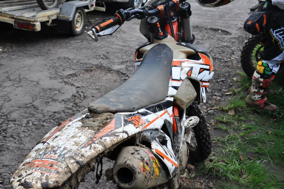 a dirt bike with an orange and white painted paint job