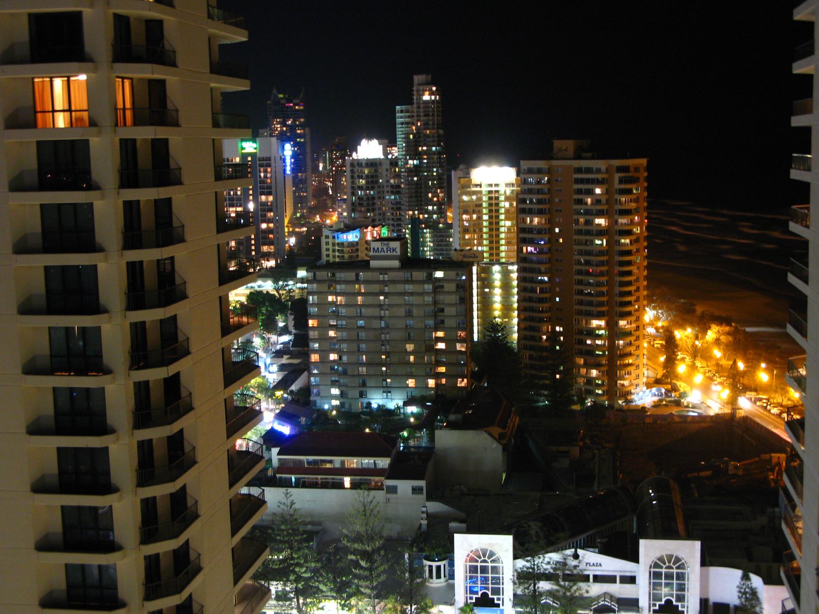 the night view of city buildings with skyscrs lit up