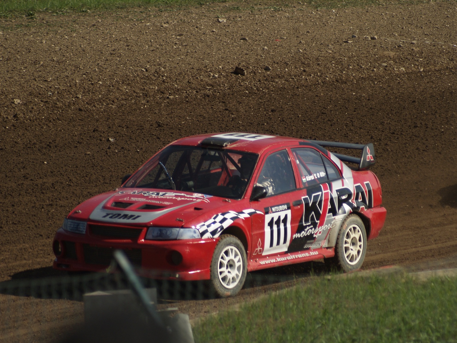 the modified racing car drives on dirt track