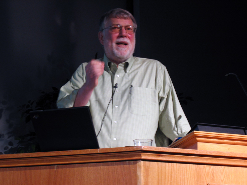 a man giving a speech behind a podium