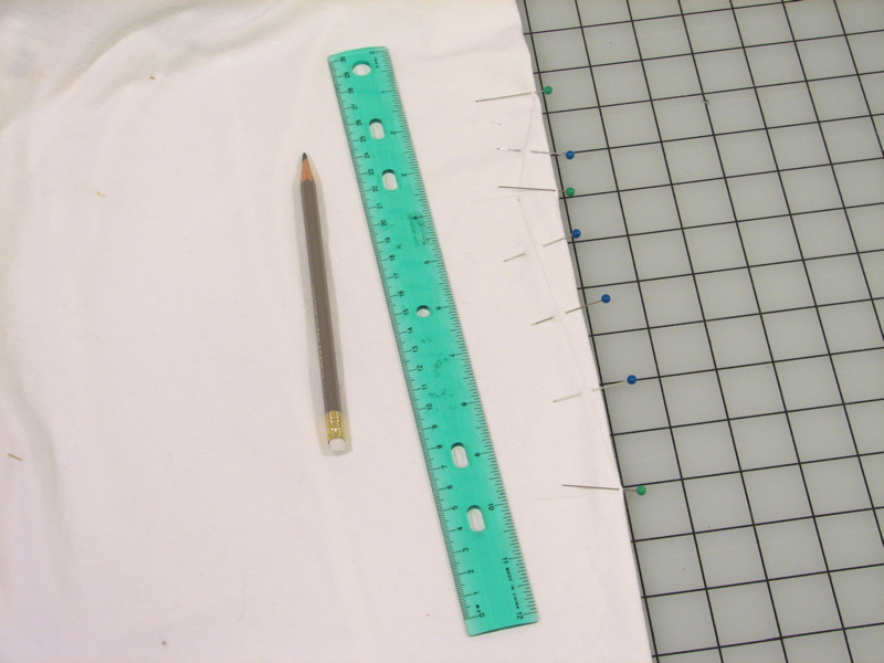 the ruler has a plastic handle with holes in it