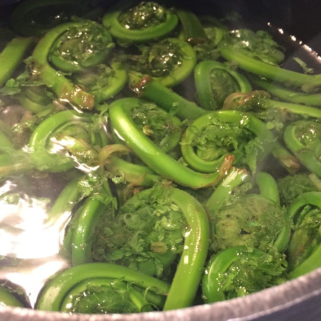 a pot with broccoli and green peppers cooking in water