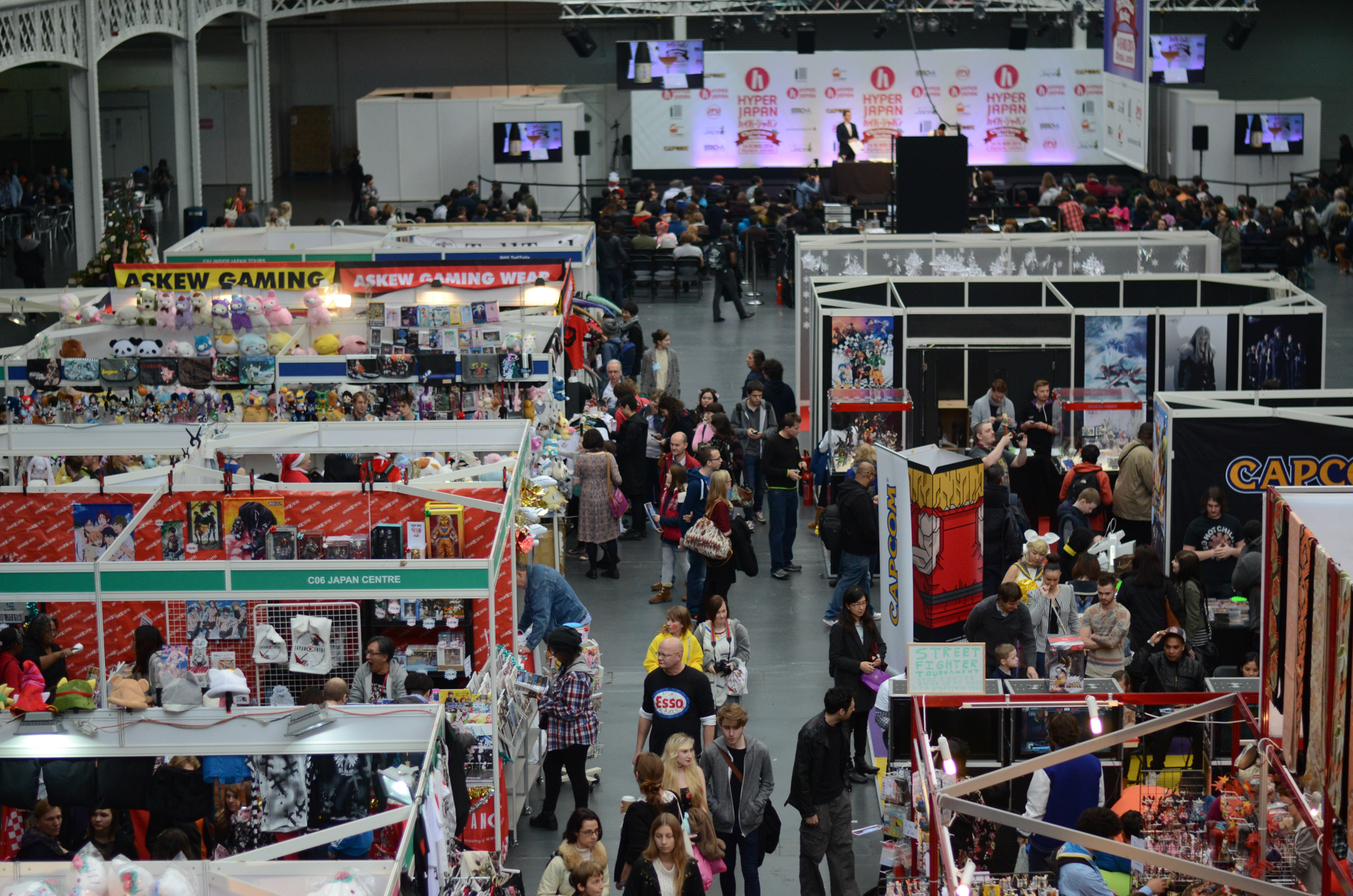 an overview of people and market stalls at a trade event