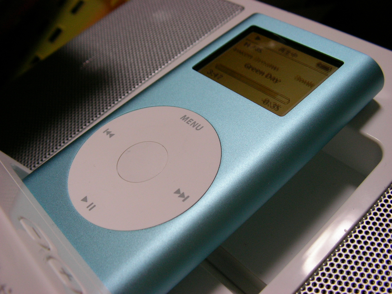 an ipod sitting on top of a white shelf