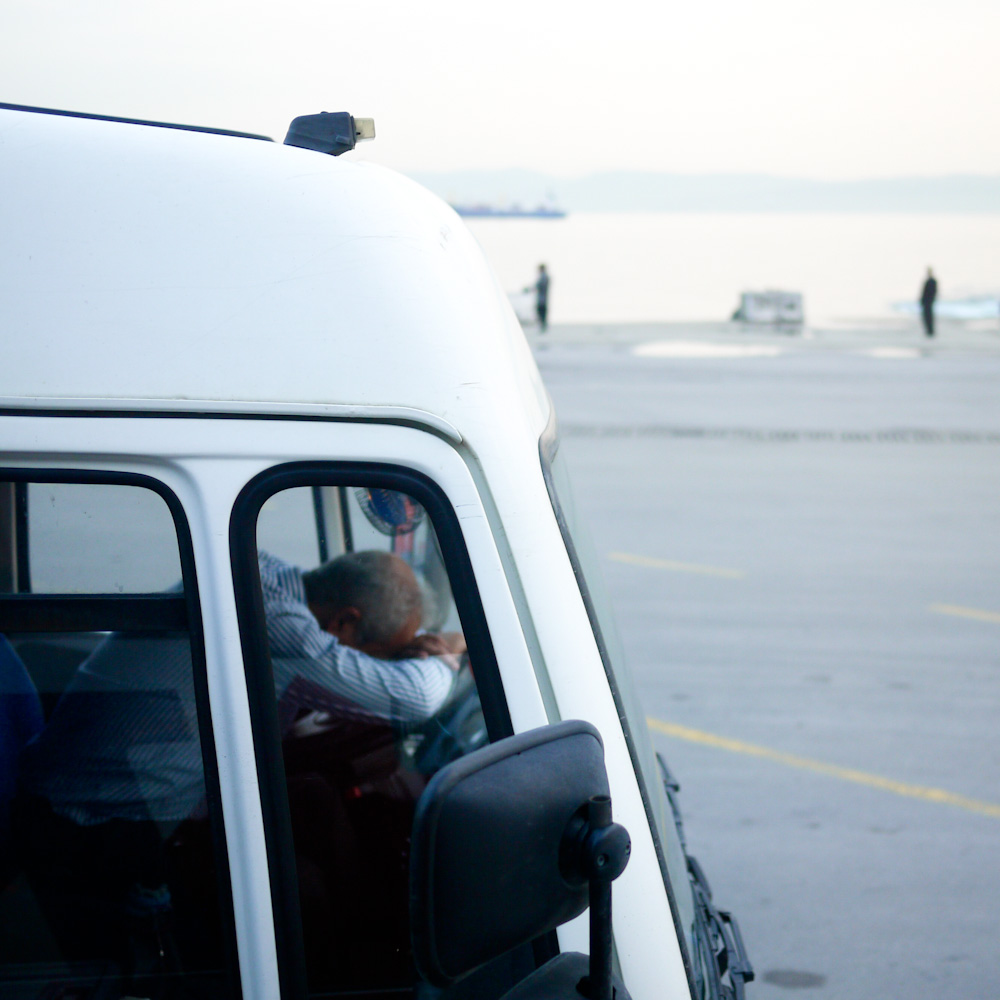 the front of a truck with passengers sitting in it