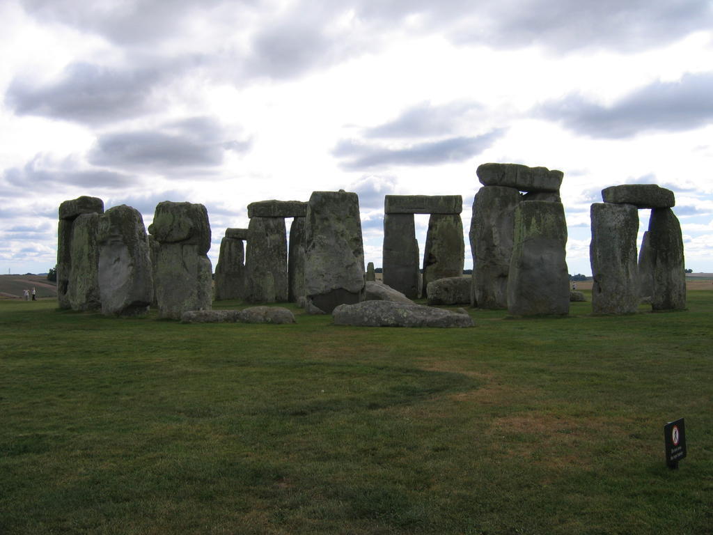 a stonehenge sculpture on the grass at stonehenge park