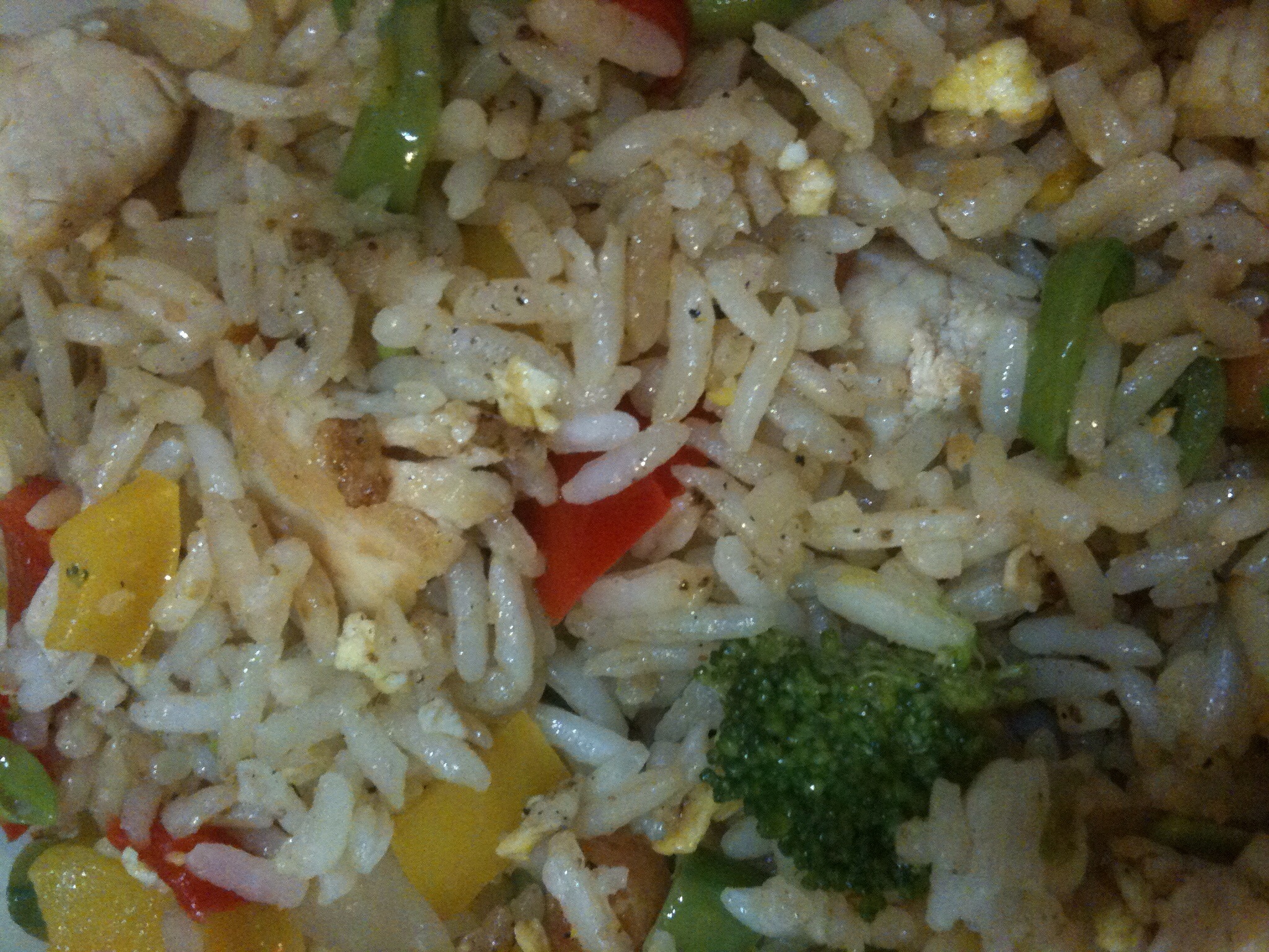 a close up of rice with fruit and vegetables