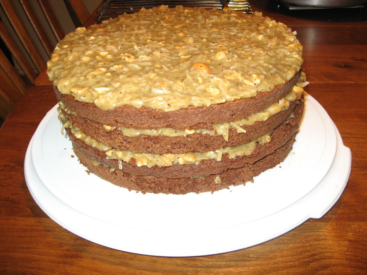 a stack of layered chocolate cake with nuts and caramel