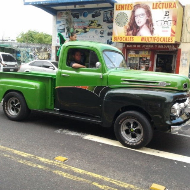 green old - time pick up truck parked outside of a cafe