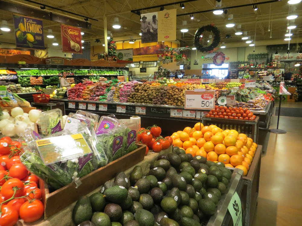 a produce market filled with lots of fresh fruits and vegetables