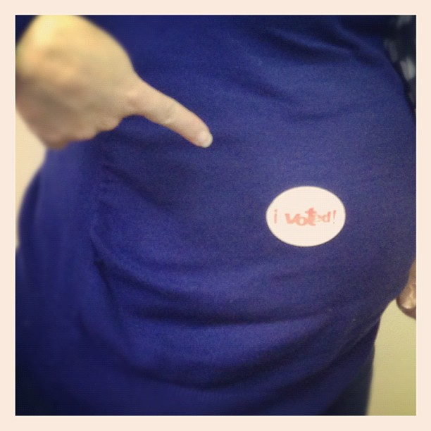 a person's hand pointing towards an ihop sticker on their back