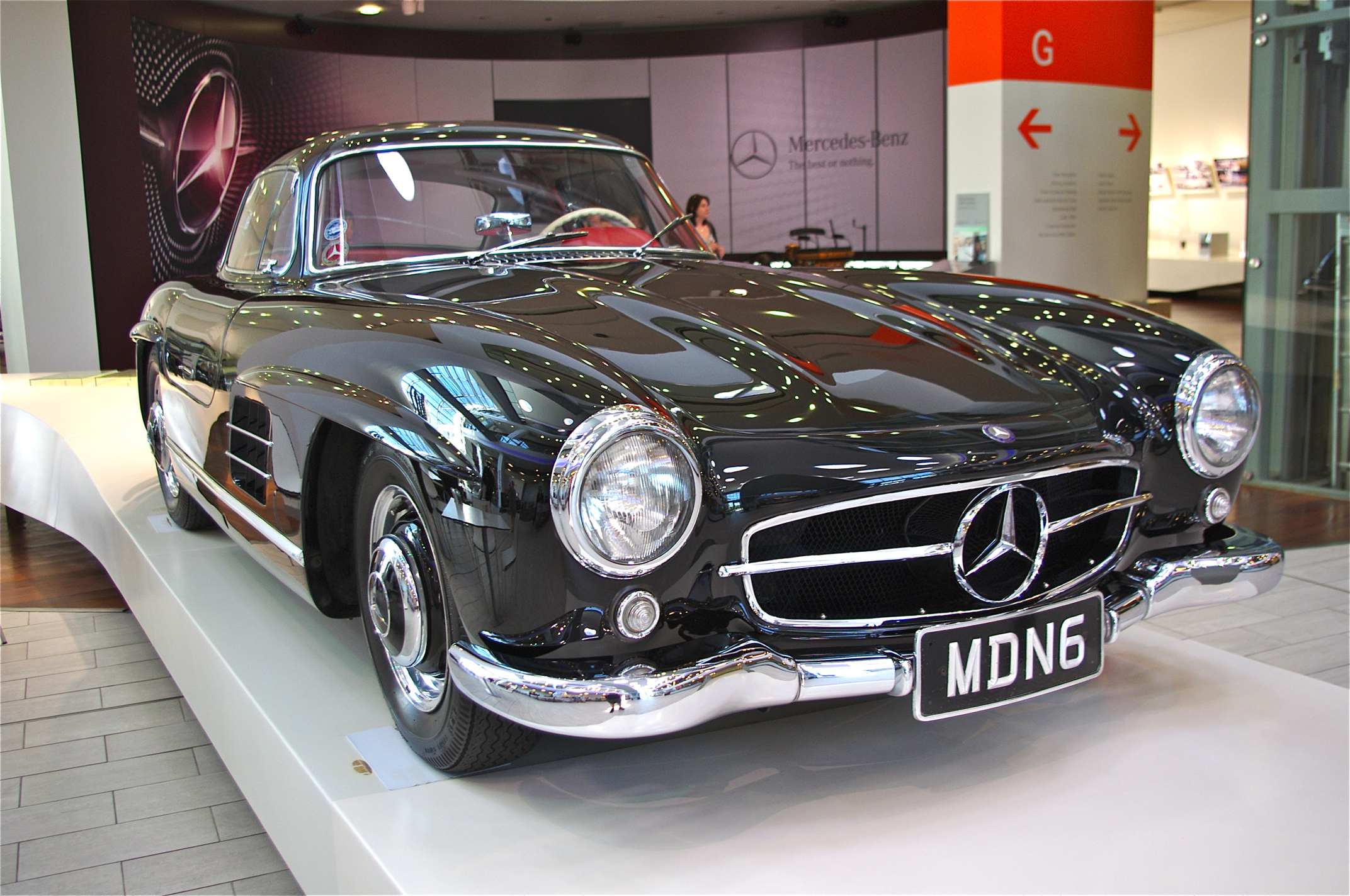 a black mercedes sports car parked on display