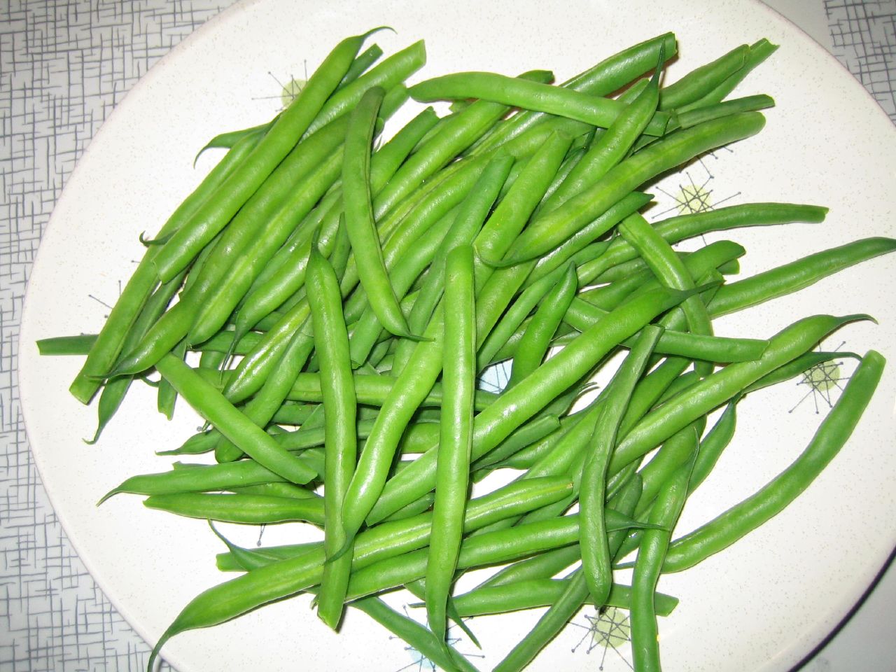 a white plate topped with a pile of green beans