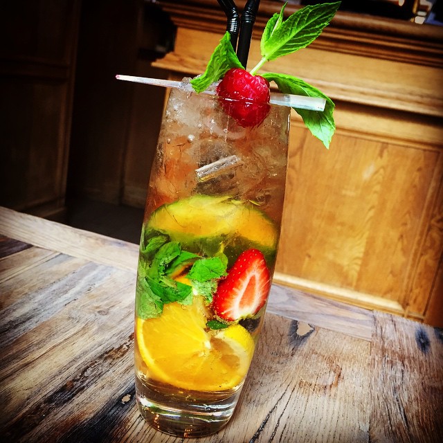 two strawberries and limes on a glass of water