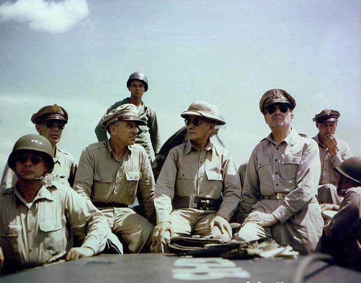 the men sit on the deck of a boat in the ocean