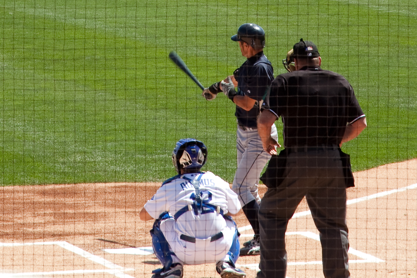 a batter at home plate holding his bat