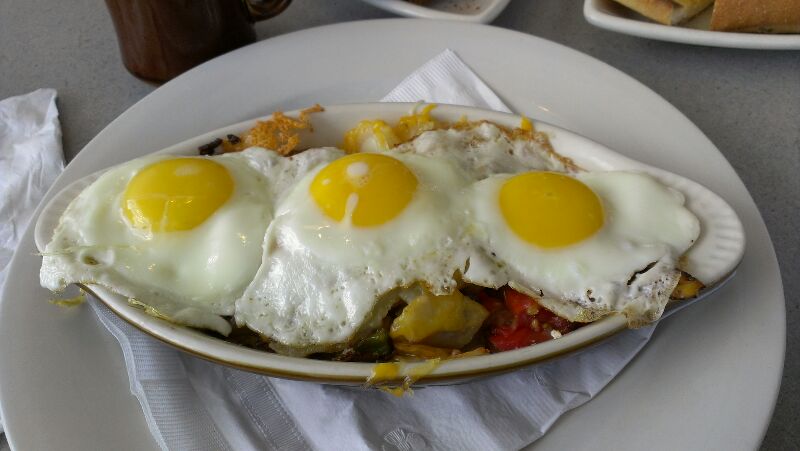 a dish with three eggs in it and two on top of a plate