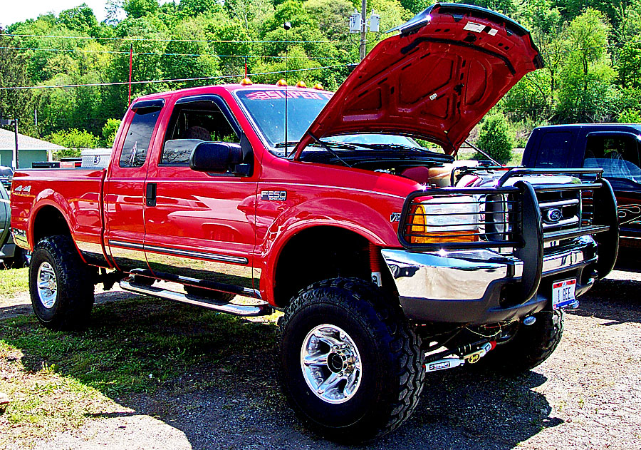 a red truck is parked in the grass