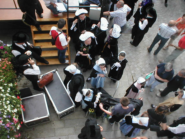 several people dressed as nunellas walking past an open briefcase