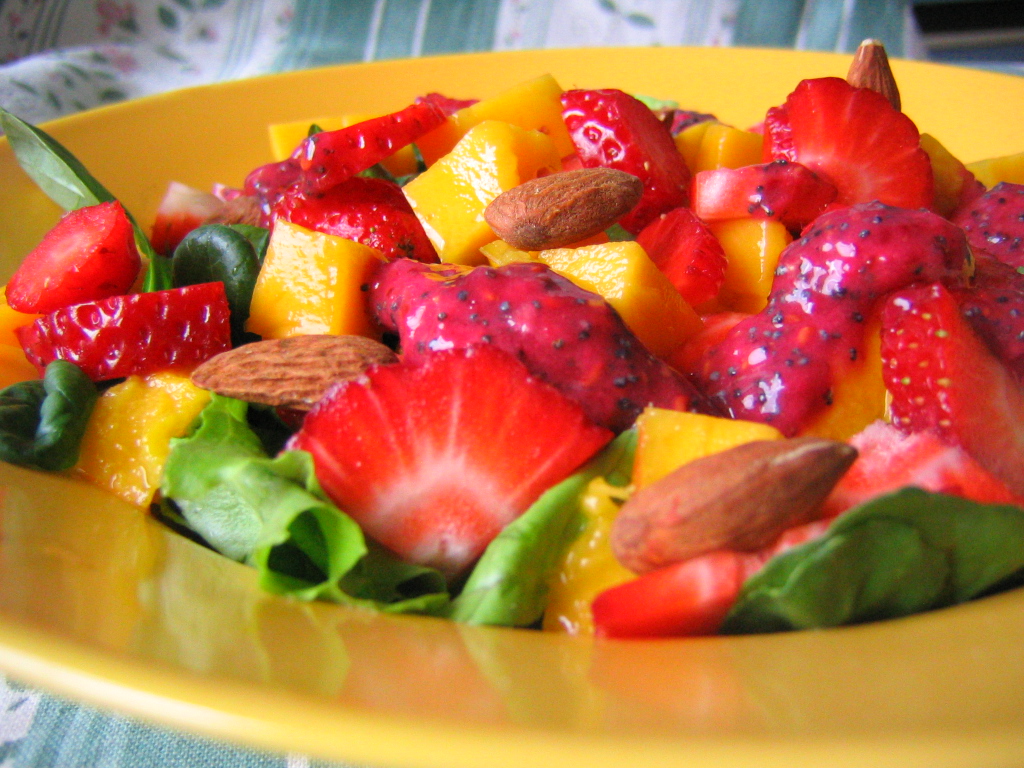 a yellow bowl with a fresh mixed fruit salad