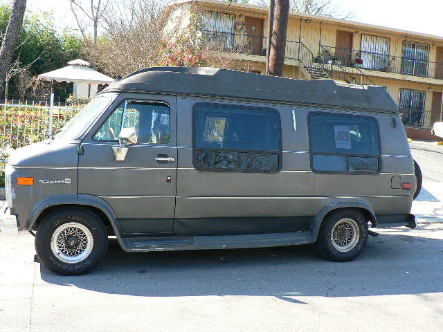 an old van is parked on the side of the road