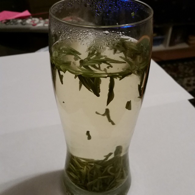 a cup filled with water and some leaves