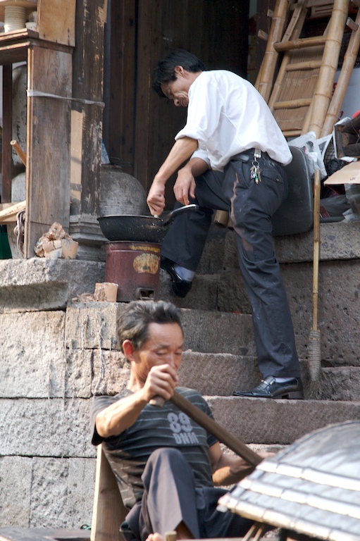 two men who are sitting on steps next to each other