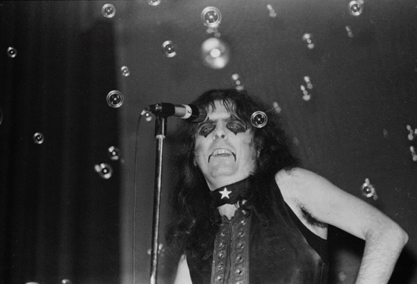 a woman on stage singing on a microphone