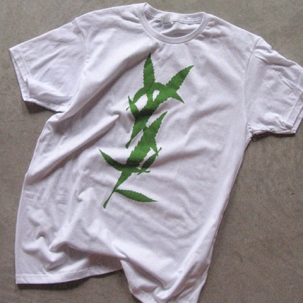 the t - shirt has an embroidered plant on it