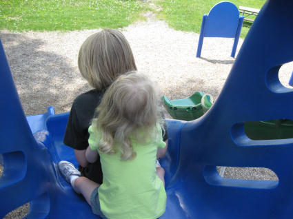 two children are playing at the playground