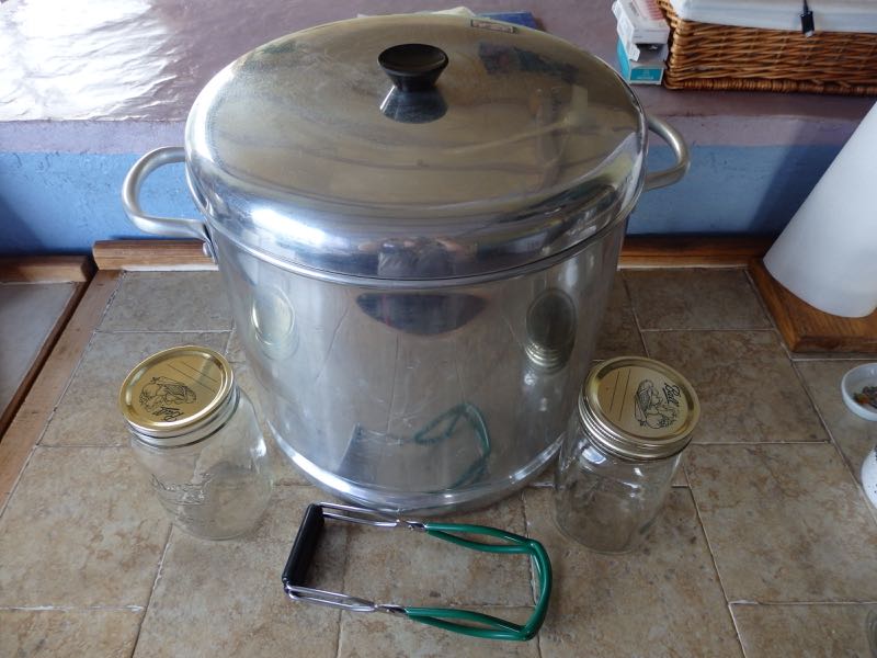 the big metal pot is sitting on top of a table