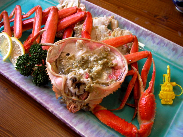 crab legs and seafood on a plate with carrots