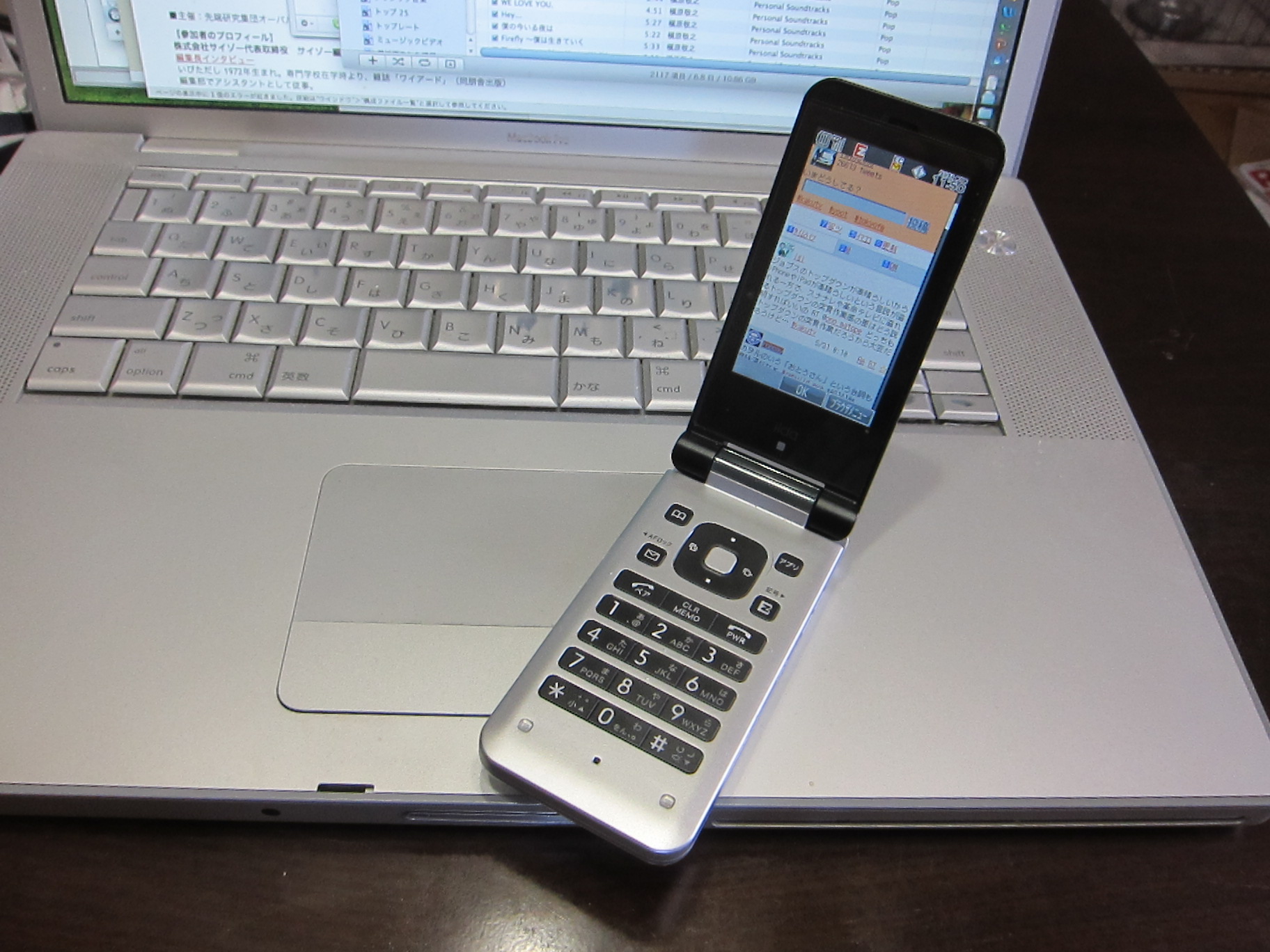 cellphone hooked to laptop, with open screen displaying keyboard