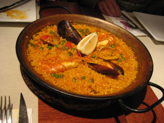 a plate of food that includes rice, shrimp, and shellfish