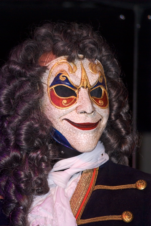 a person wearing a fake mask with long dark hair