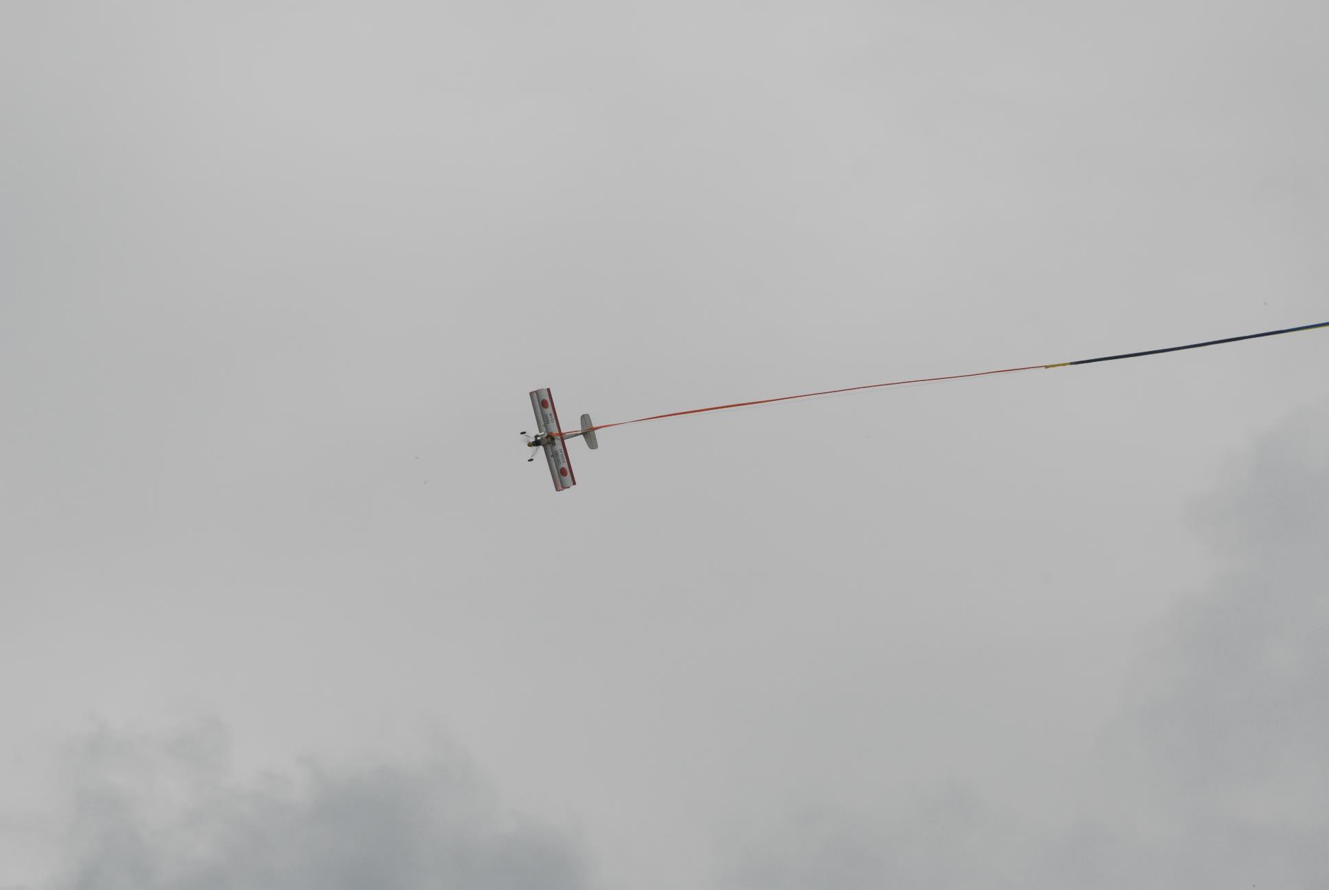 a kite with a long red rope attached to it