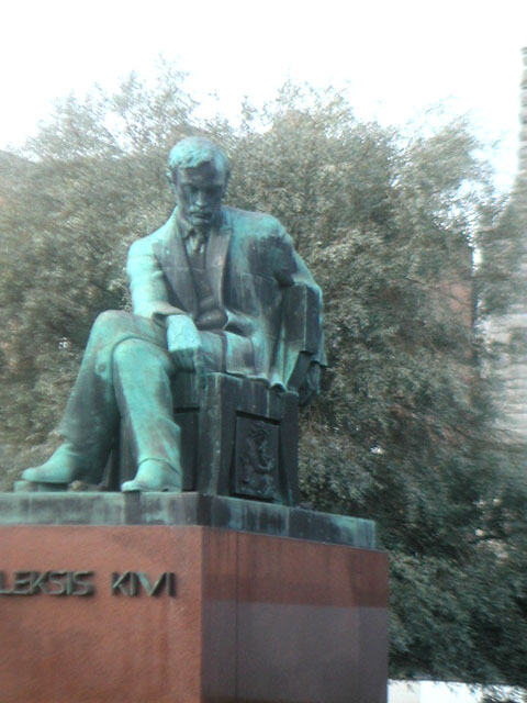a sculpture of a man with a cane and a suit
