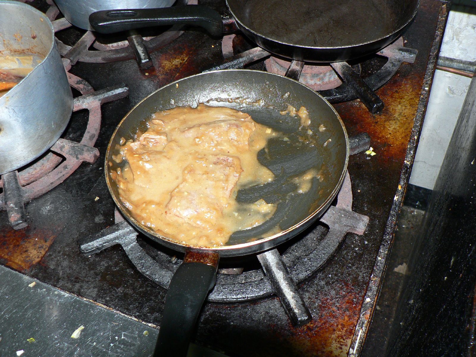 a pan on a stove covered in food